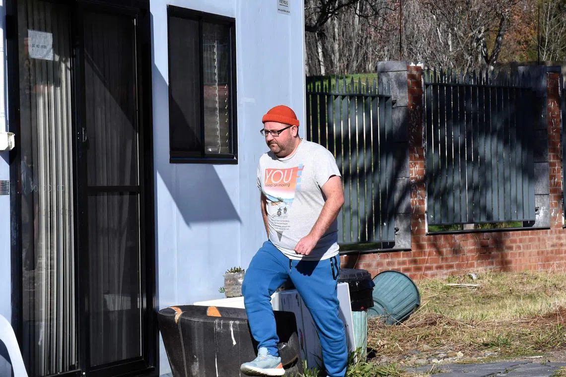 A Russian diplomat walking back to a security shed on a parcel of land where Australia blocked Russia from building a new embassy, in Canberra on June 24, 2023.