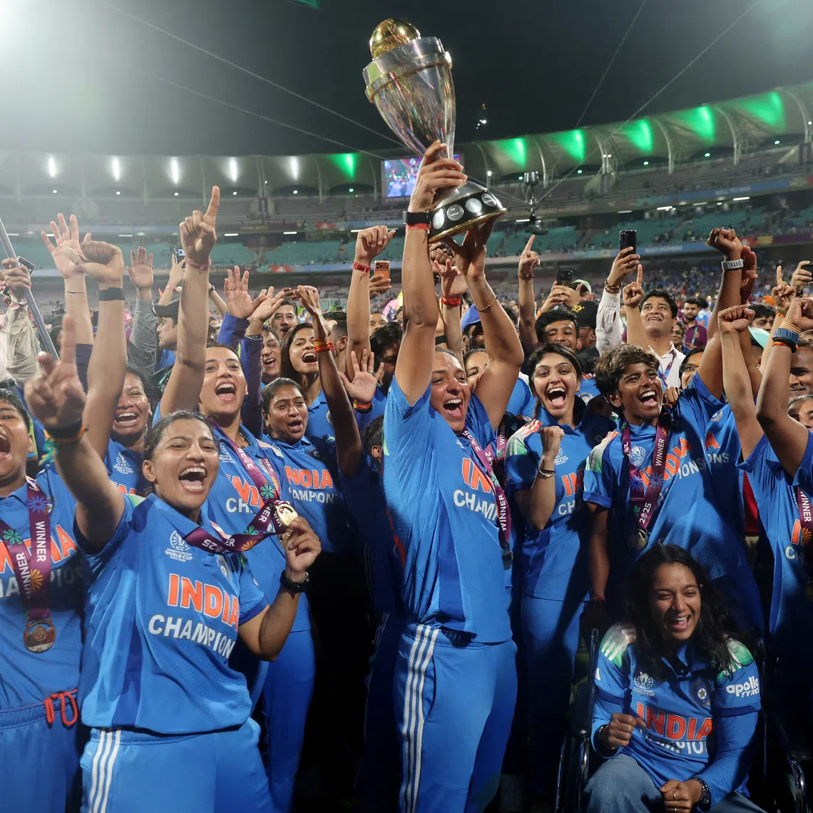 Cricket - ICC Women's World Cup - Final - India v South Africa - DY Patil Stadium, Navi Mumbai, India - November 2, 2025 India's Harmanpreet Kaur and teammates celebrate with the trophy after winning the ICC Women's World Cup REUTERS/Francis Mascarenhas