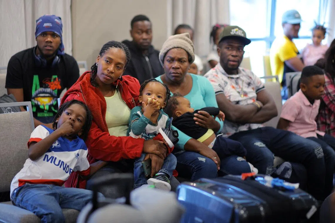 Immigrants from Haiti who recently arrived in Boston from other parts of the United States listen to instructions from representatives of La Colaborativa, a non-profit community services organization based in Chelsea, as they arrive at temporary housing in a hotel in Everett, Massachusetts, U.S., July 10, 2023.     REUTERS/Brian Snyder/File Photo