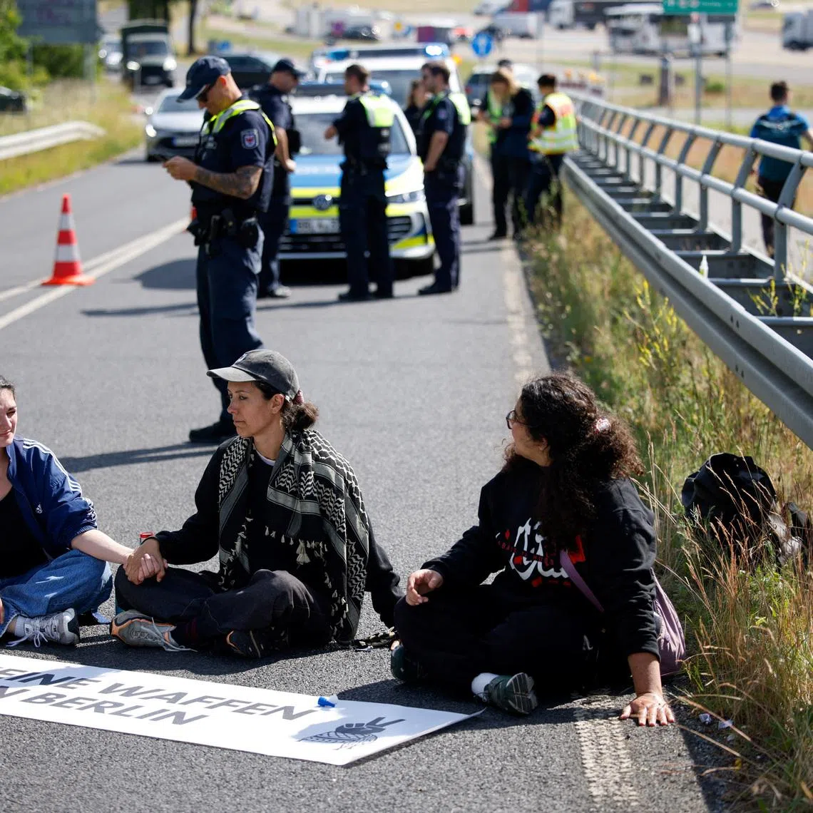 Activists block a road to the venue during protest on the opening day of the International Aerospace Exhibition ILA at Schoenefeld Airport in Berlin, Germany, June 10, 2026. REUTERS/Axel Schmidt