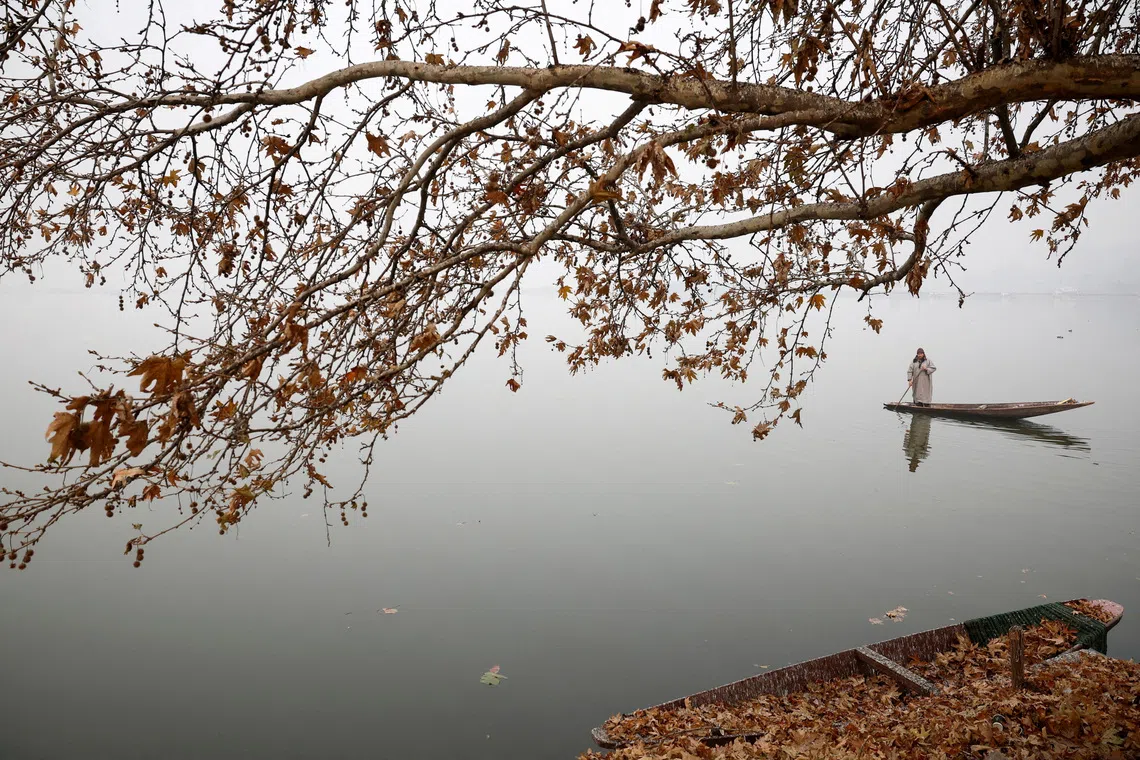 A man rowing his boat on a cold morning across Dal Lake in Srinagar, Indian-administered Kashmir, on Dec 2, 2025. 