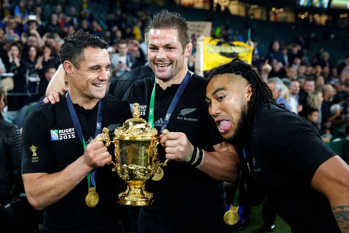 FILE PHOTO: Daniel Carter, Richie McCaw and Ma'a Nonu of New Zealand (L-R) pose with the Webb Ellis trophy after winning the Rugby World Cup Final against Australia at Twickenham in London, October 31, 2015. REUTERS/Stefan Wermuth/File Photo