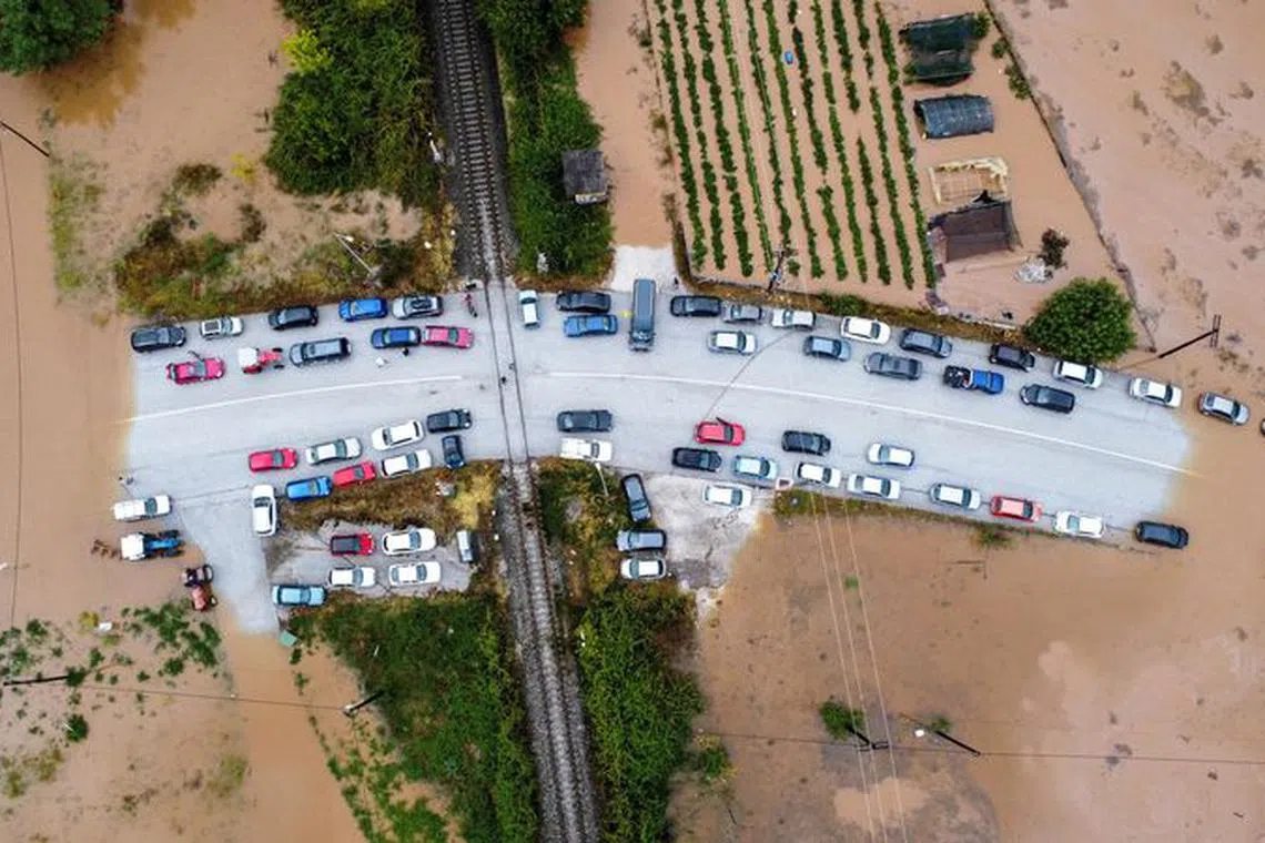 FILE PHOTO: An aerial view of cars stuck on a bridge surrounded by flood waters, as storm Daniel hits central Greece, in the village of Flamouli, near Trikala, Greece, September 7, 2023. REUTERS/Stergios Spiropoulos