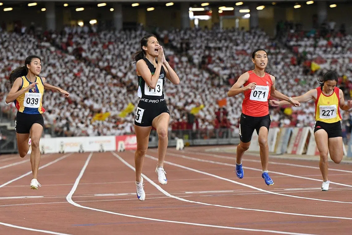 Clara Lim (second from left) celebrating after taking gold in the A Div Girls 100m final.