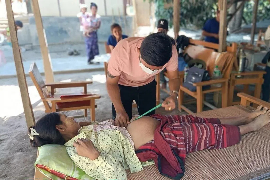 hypregnant - A doctor working with Youths for Community Myaung, a civil society group, examining a pregnant war refugee in Myaung township in Myanmar's Sagaing region on Dec 1, 2023.


Byline: Courtesy of Youths for Community Myaung