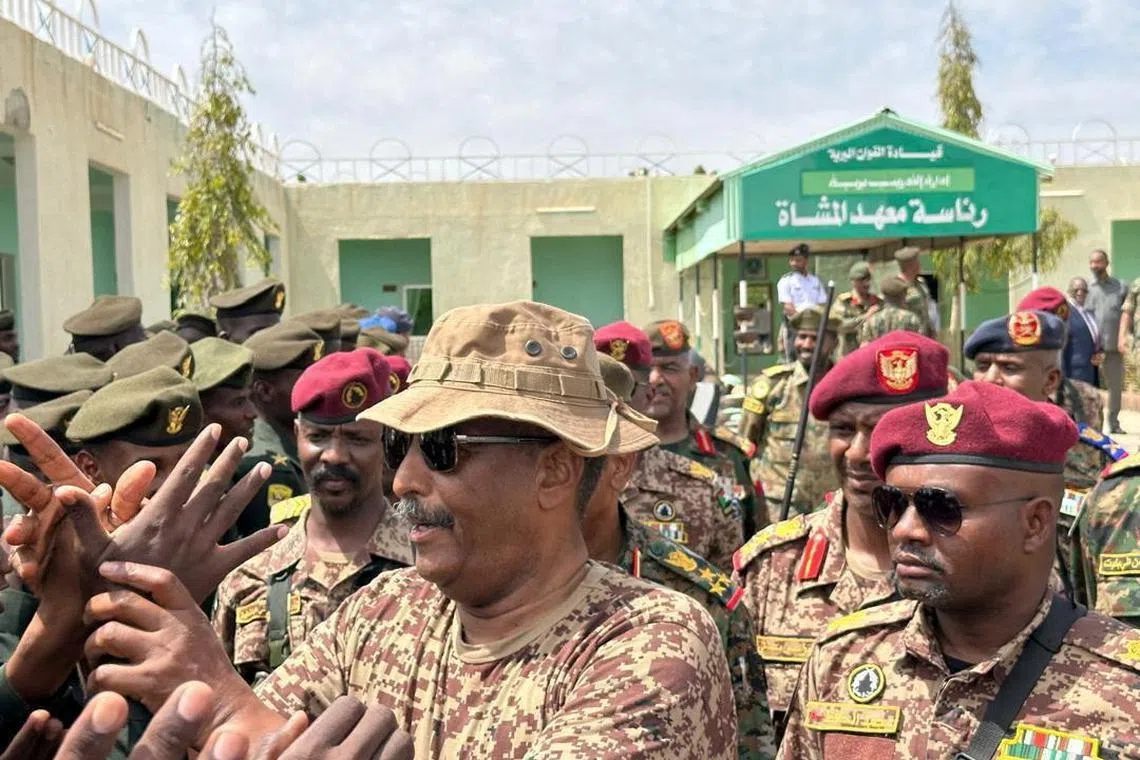 FILE PHOTO: Head of Sudan's armed forces Abdel Fattah al-Burhan greets army officers after a drone strike hit an army base where he attended a graduation ceremony, in Gebit, Sudan, July 31, 2024. Sudanese Sovereign Council Media Office/Handout via REUTERS/File Photo
