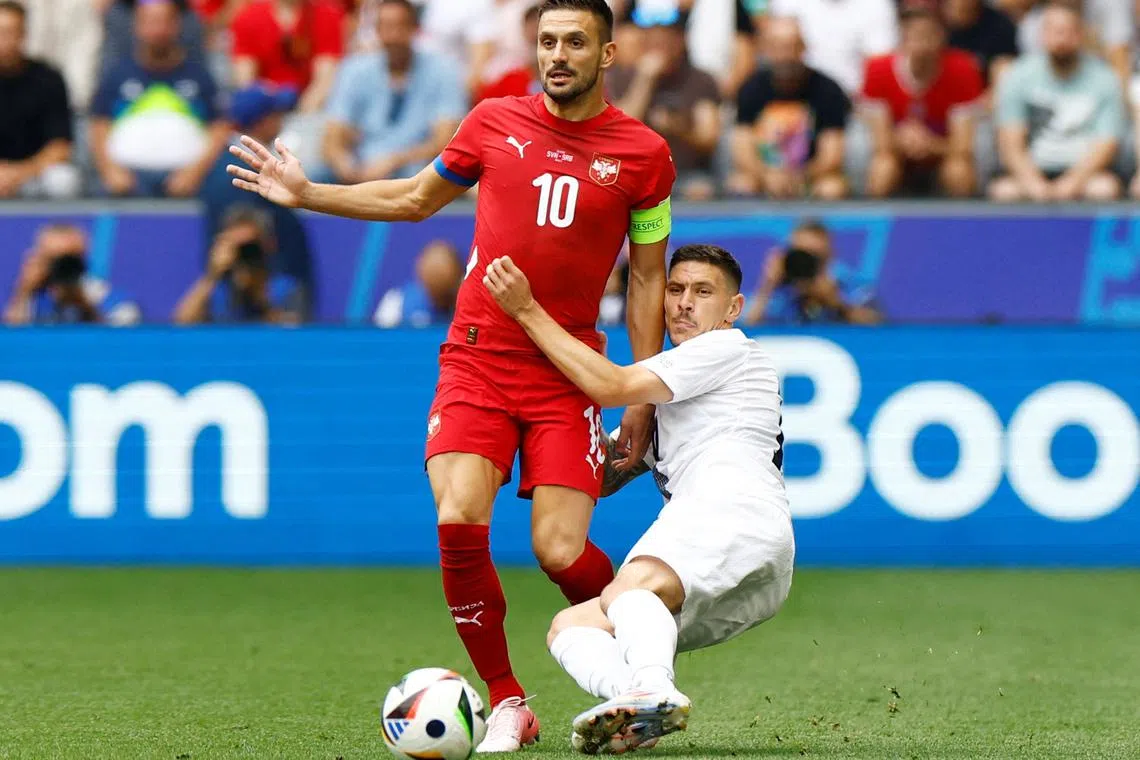 FILE PHOTO: Soccer Football - Euro 2024 - Group C - Slovenia v Serbia - Munich Football Arena, Munich, Germany - June 20, 2024 Serbia's Dusan Tadic in action with Slovenia's Erik Janza REUTERS/Michaela Stache/File Photo