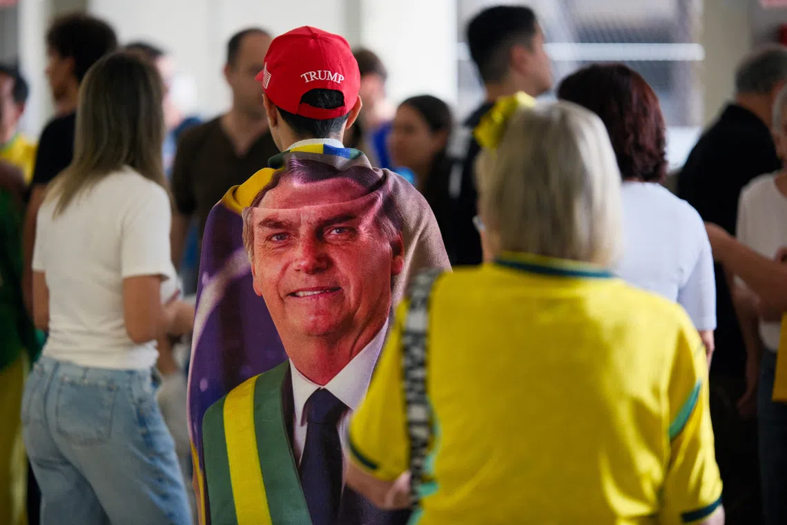 A person wears an image of Brazil's former president Jair Bolsonaro and a US President Donald Trump hat, during the general election, in Brasilia, Brazil, October 4, 2026. REUTERS/Diego Herculano