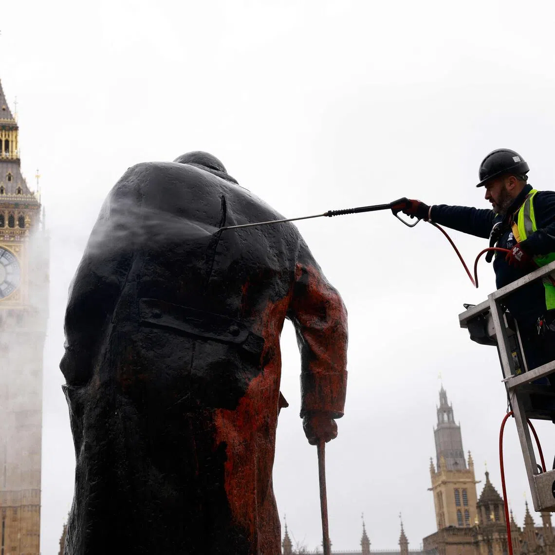 Graffiti on a statue of Britain’s former Prime Minister Winston Churchill is removed by a worker in Parliament Square, in central London on Feb 27.