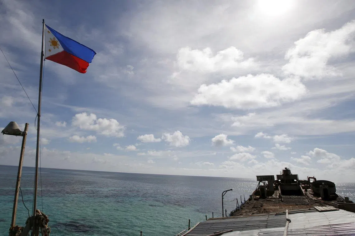 FILE PHOTO: A Philippine flag flutters on BRP Sierra Madre, a dilapidated Philippine Navy ship that has been aground since 1999, on the disputed Second Thomas Shoal, part of the Spratly Islands, in the South China Sea March 29, 2014. REUTERS/Erik De Castro/File Photo