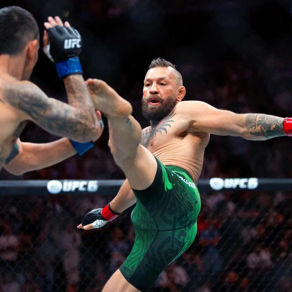 Jul 11, 2026; Las Vegas, Nevada, USA; Conor McGregor (right) attempts a flying kick at the start of his fight against Max Holloway during UFC 329 at T-Mobile Arena. Mandatory Credit: Mark J. Rebilas-Imagn Images     TPX IMAGES OF THE DAY