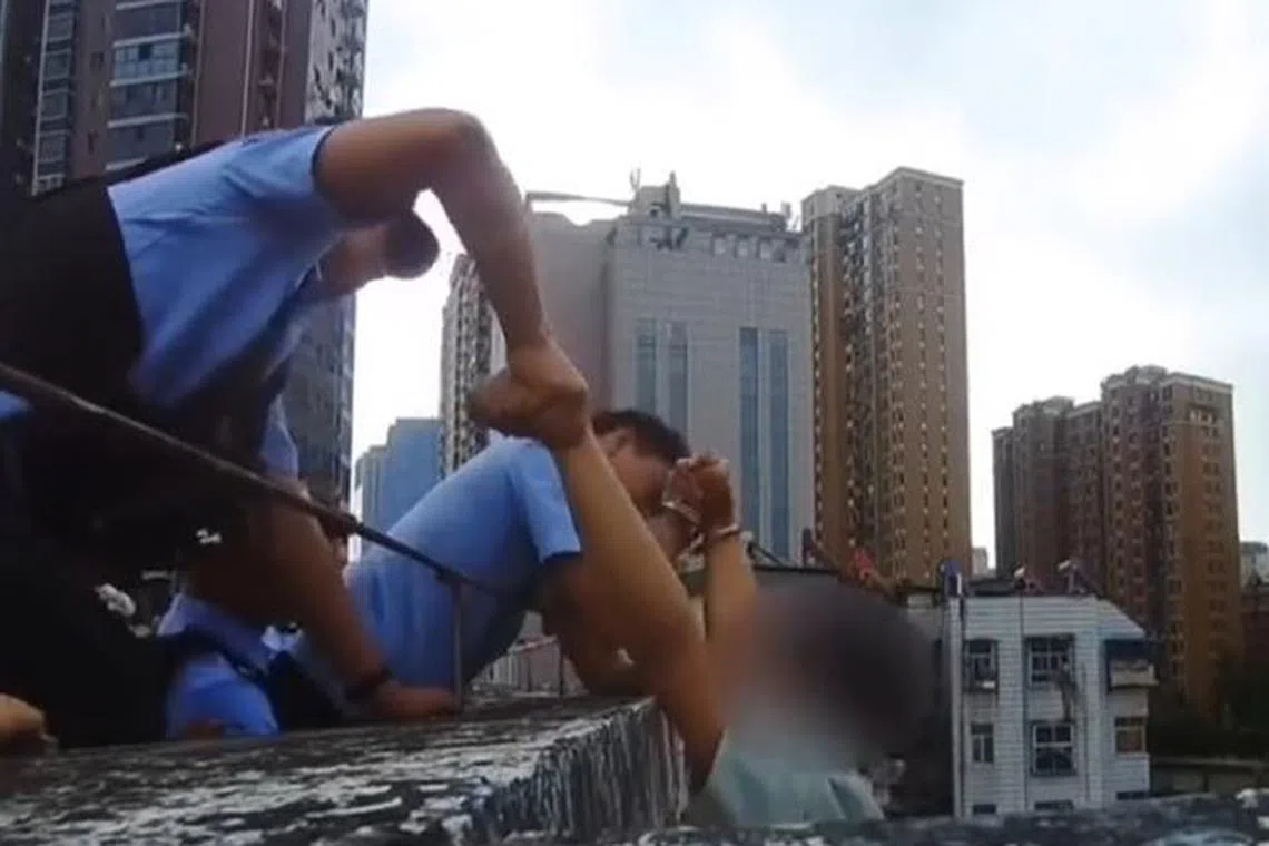 In the video, Chinese police officer Li Yansong could be heard telling the man to hold on to his hand while his partner reassured Mr Chen to stay calm.