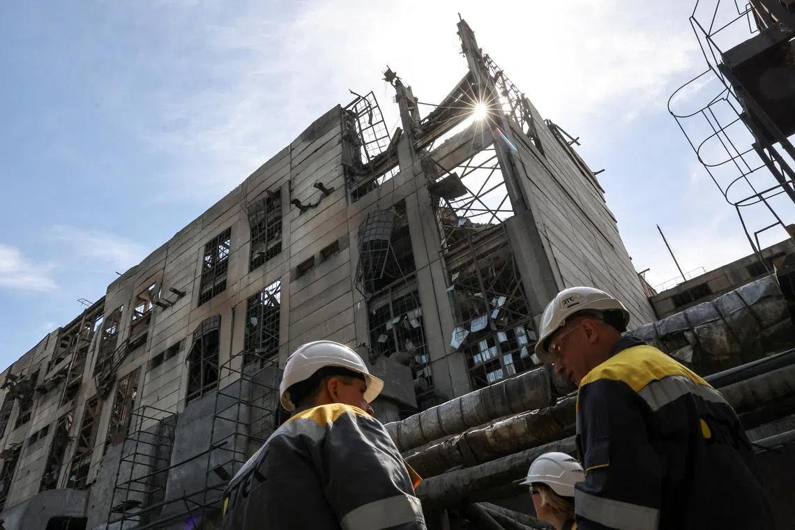 Thermal power plant employees appear on site at the building damaged by recent Russian missile strikes, amid Russia's attack on Ukraine, at an undisclosed location in the west of Ukraine May 2, 2024. REUTERS/Roman Baluk