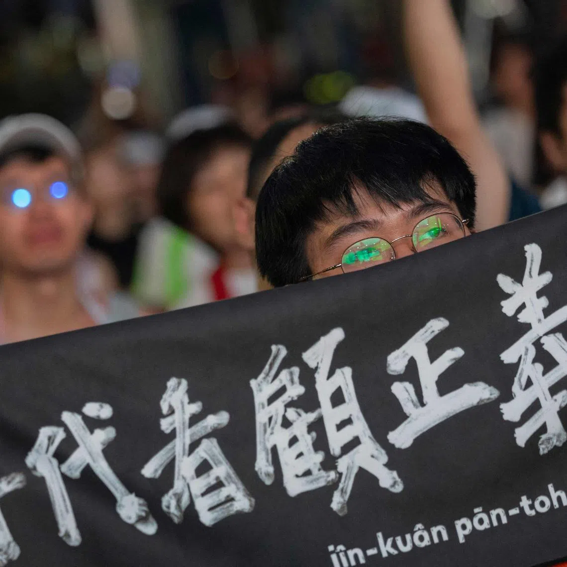CORRECTION / A man displays a banner as he awaits the results of the recall election in Taipei on July 26, 2025. Taiwanese voters turned out at schools, churches and community centres on July 26, to cast their ballot in a high-stakes recall election that could give President Lai Ching-te's party control of the parliament. (Photo by Yu Chien Huang / AFP) / “The erroneous mention[s] appearing in the metadata of this photo by I-Hwa Cheng has been modified in AFP systems in the following manner: [Yu Chien Huang] instead of [I-Hwa Cheng]. Please immediately remove the erroneous mention[s] from all your online services and delete it (them) from your servers. If you have been authorized by AFP to distribute it (them) to third parties, please ensure that the same actions are carried out by them. Failure to promptly comply with these instructions will entail liability on your part for any continued or post notification usage. Therefore we thank you very much for all your attention and prompt action. We are sorry for the inconvenience this notification may cause and remain at your disposal for any further information you may require.”