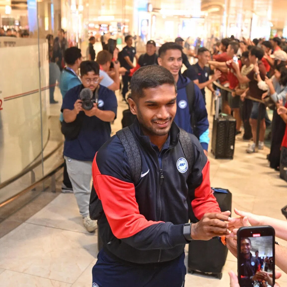 Lions captain Hariss Harun greeting fans at Changi Airport on his return from Hong Kong on Nov 19 after their historic Asian Cup qualification campaign. 