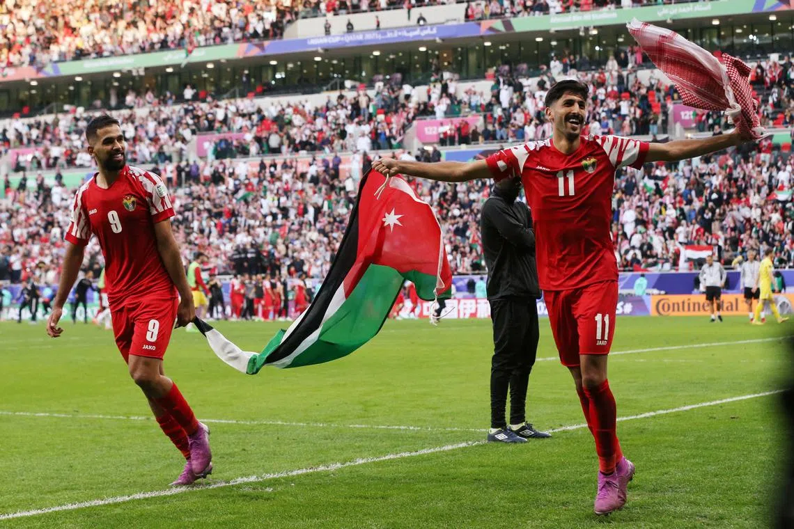 Jordan's Yazan Al-Naimat and Ali Olwan celebrate after beating Tajikistan 1-0 in the Asian Cup quarter-finals.
