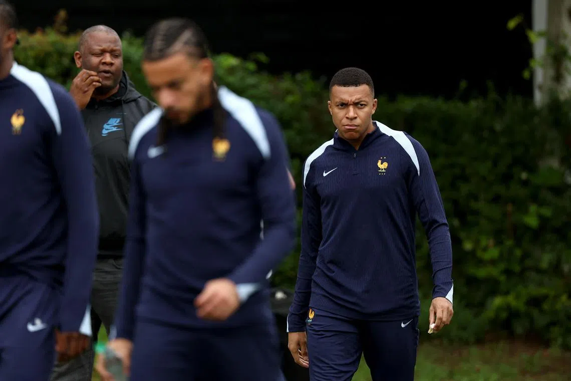 Kylian Mbappe (right) arriving for a training session on June 7 for France's national team, near Stuttgart, southwestern Germany.