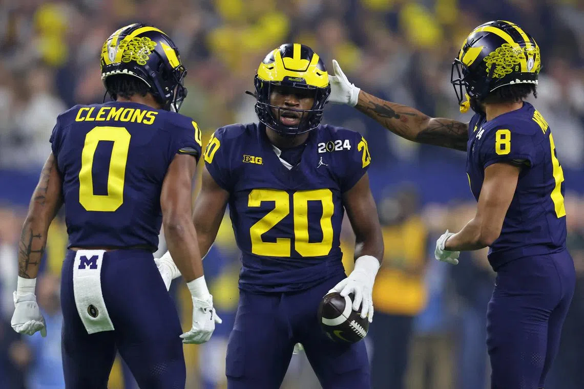 FILE PHOTO: Jan 8, 2024; Houston, TX, USA; Michigan Wolverines running back Kalel Mullings (20) is congratulated by after a first down against the Washington Huskies by wide receiver Darrius Clemons (0) and wide receiver Tyler Morris (8) during the first quarter in the 2024 College Football Playoff national championship game at NRG Stadium. Mandatory Credit: Thomas Shea-USA TODAY Sports/File photo