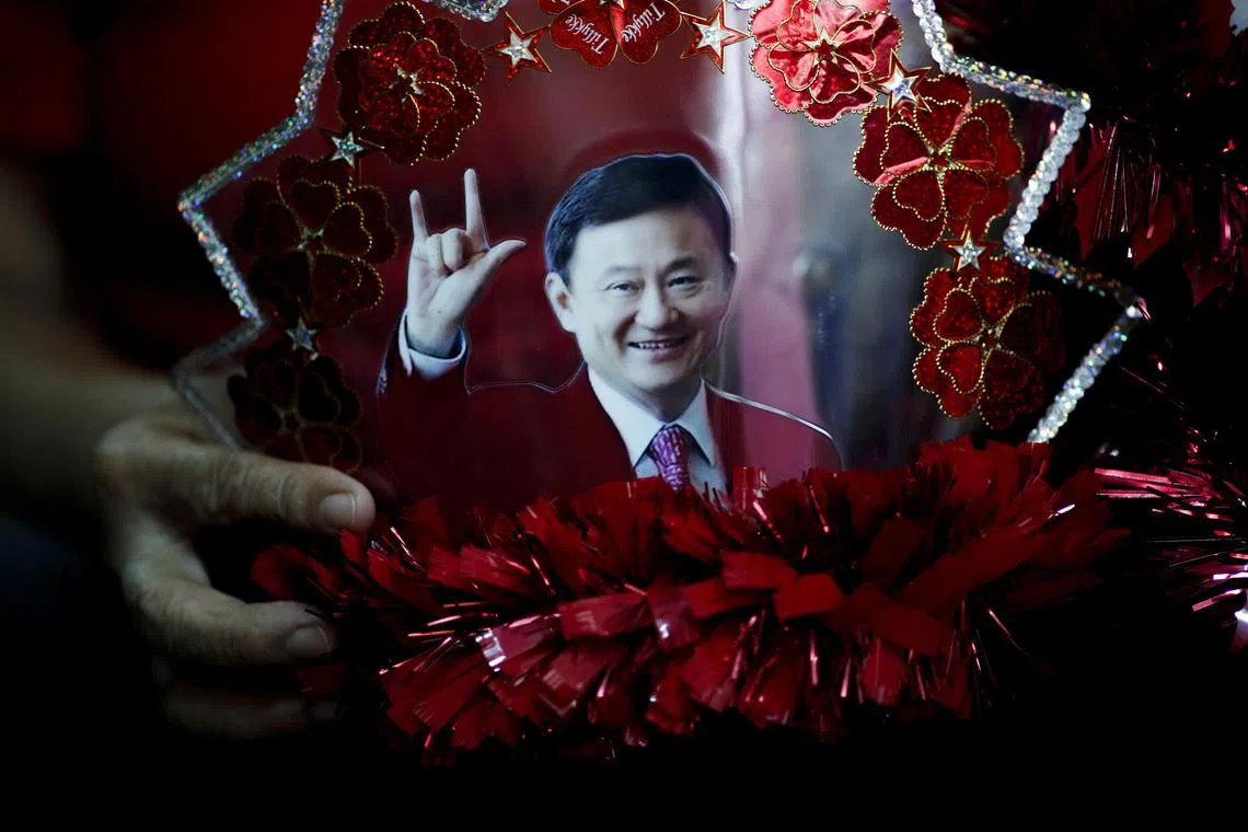 epa10597949 Hardcore supporter of the Pheu Thai party Vimol Jia, 68, holds a self-made cap decorated with a photograph of their beloved coup-ousted former Prime Minister Thaksin Shinawatra, at a flat in a low-income community in Bangkok, Thailand, 20 April 2023 (issued 29 April 2023). The Pheu Thai Party is the third generation of a political party founded by billionaire and ousted former Thai Prime Minister Thaksin Shinawatra that will be contesting in the upcoming general elections on 14 May. The party nominated the youngest daughter of Thaksin, Paetongtarn Shinawatra, 37, and a property tycoon-turned-politician Srettha Thavisin to be the party’s prime minister candidates in the election. They unveiled a populist program to woo the majority of low income voters and rural communities with the aim to topple the military-backed government.  EPA-EFE/RUNGROJ YONGRIT  ATTENTION: This Image is part of a PHOTO SET