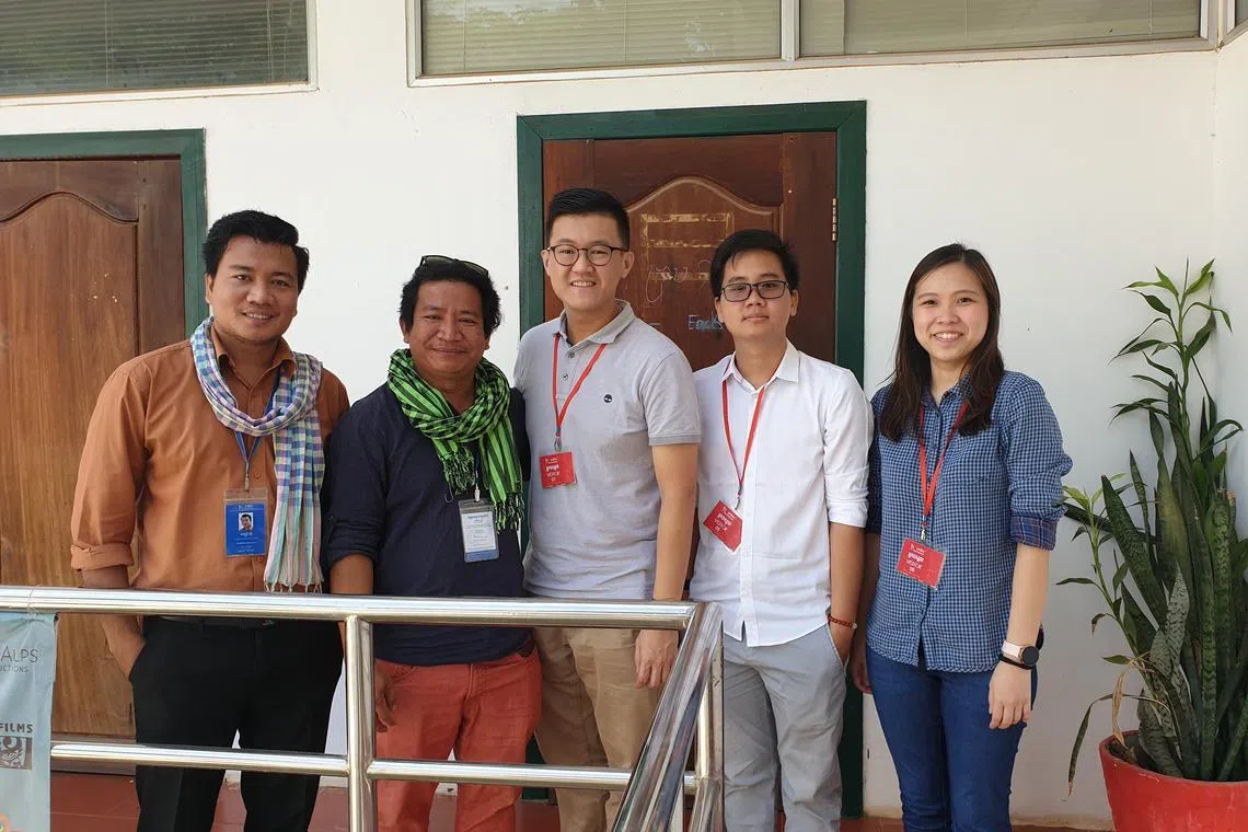 Singaporean Wang JunYong (centre) moved to Cambodia in 2018 to run an international school.