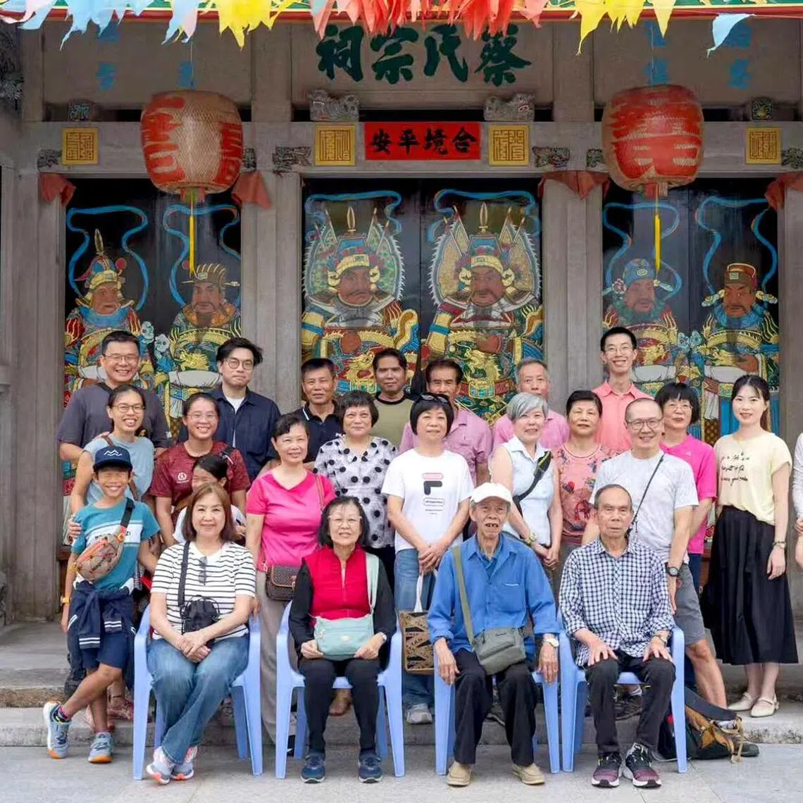 Jasmine Goh-Chew (third row, first from left), her husband Raymond Chew (top row, first from left) and her parents Chua Kee Chu and Goh Kian Chen (front row, second and third from left) with other relatives outside the Chua ancestral home.