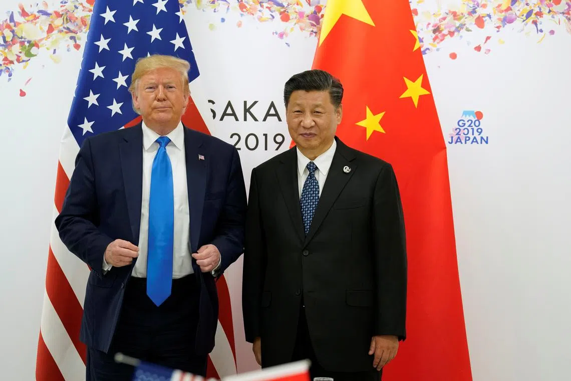 FILE PHOTO: U.S. President Donald Trump and China's President Xi Jinping pose for a photo ahead of their bilateral meeting during the G20 leaders summit in Osaka, Japan, June 29, 2019. REUTERS/Kevin Lamarque/File Photo