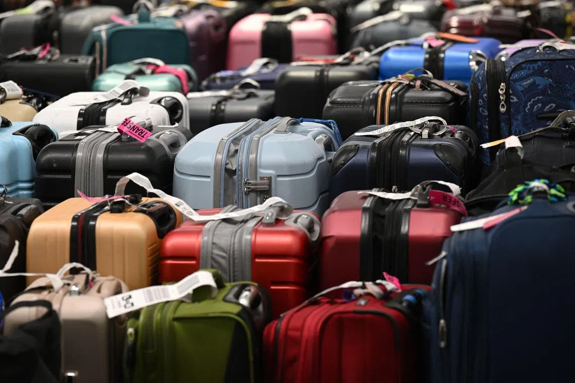 This file photograph taken on December 28, 2022, shows unclaimed luggage of Southwest Airlines customers sits in the baggage claim area, at the Los Angeles International Airport in Los Angeles. - Stylized suitcases, logotyped trunks or connected bags... Tourism is making a comeback after the pandemic and has boosted the luggage market, making it all the more attractive to luxury brands. (Photo by Robyn BECK / AFP)