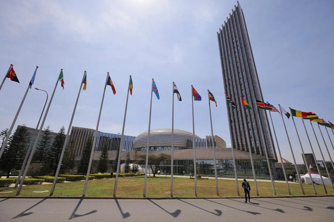 FILE PHOTO: A delegate walks next to African Union (AU) member states flags ahead of the 38th Ordinary Session of the Heads of State and Government of the African Union at the African Union Commission (AUC) headquarters in Addis Ababa, Ethiopia, February 14, 2025. REUTERS/ Tiksa Negeri/File Photo