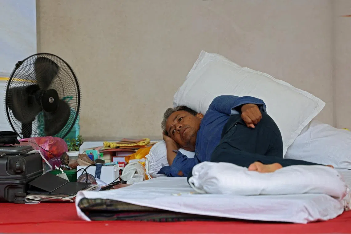 Sonam Wangchuk, an Indian education reformer who has been on hunger strike, rests on stage during a sit-in protest in New Delhi on July 13.
