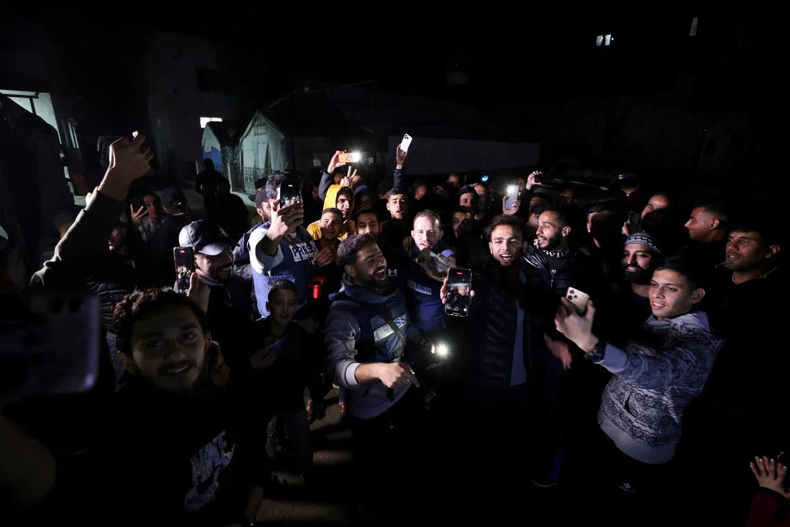 Palestinians and journalists react to news on a ceasefire deal with Israel, in Gaza City, on Jan 15.