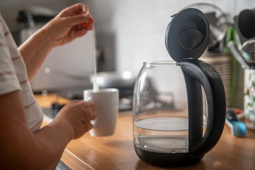 Best electric kettles in Singapore: Woman making tea using an electric kettle