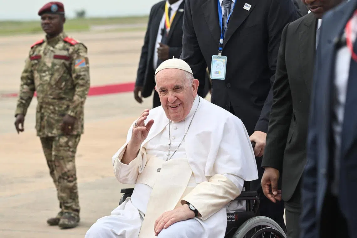 Pope Francis struggles to walk due to a chronic knee ailment and had to be lowered from the plane, then pushed in a wheelchair onto the red carpet leading to the terminal.