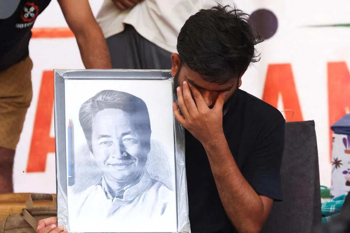 Abhijeet Dipke, head of the Cockroach Janta Party, holds a picture of Sonam Wangchuk, an Indian education reformer who had been on a hunger strike to demand the resignation of Indian Education Minister Dharmendra Pradhan, at Jantar Mantar in New Delhi, India, on July 18.