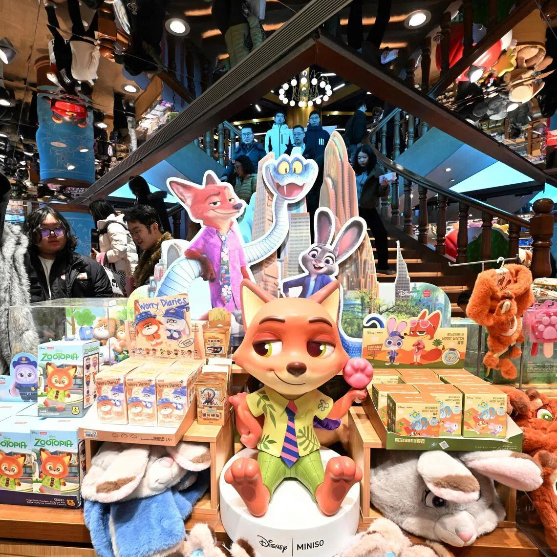People visit a Miniso shop in Beijing with Zootopia merchandises on display on Dec 20.