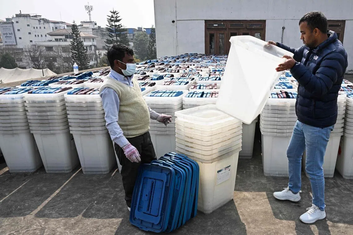 Election officials inspect ballot boxes before they are dispatched from the Election Commission office in Kathmandu on Feb 9, 2026, ahead of Nepal's general elections.