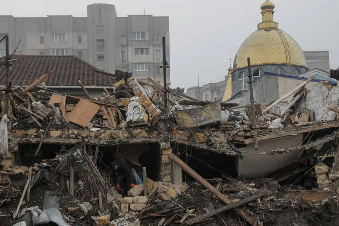 A local resident removes debris at the site where a residential building was destroyed during a Russian missile strike, amid Russia's attack on Ukraine, in Odesa, Ukraine December 29, 2023. REUTERS/Nina Liashonok