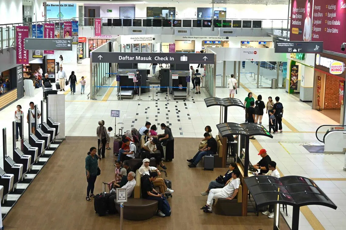 Travellers waiting at Sultan Abdul Aziz Shah Airport in Subang, Malaysia, on Oct 13. Worsening haze and low visibility have forced airlines to delay and divert flights across the region, including Firefly which cancelled several flights to and from Subang in Malaysia and Seletar Airport in Singapore.