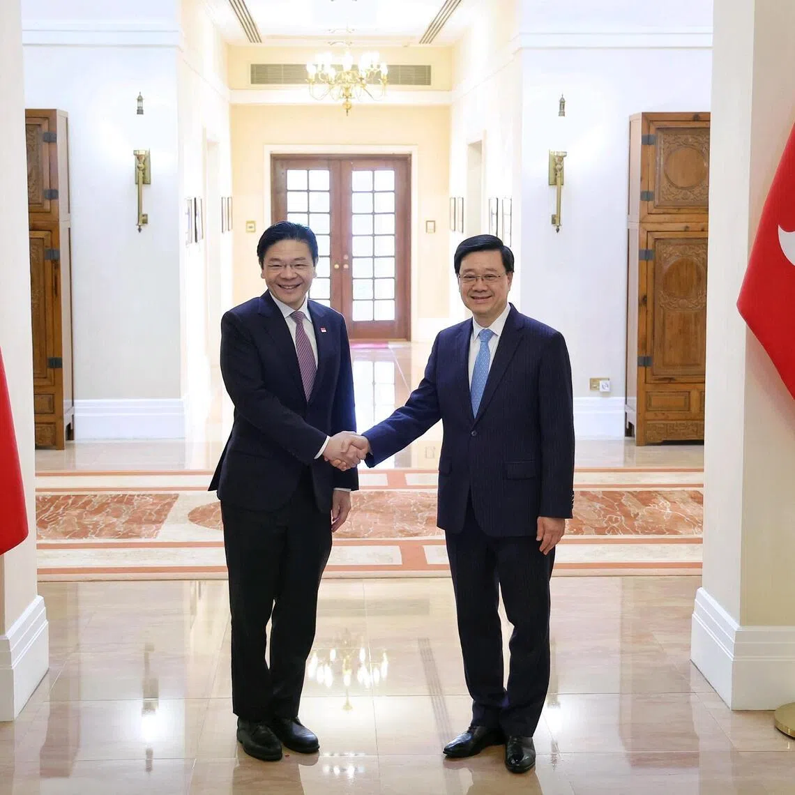 Prime Minister Lawrence Wong shaking hands with Hong Kong Chief Executive John Lee during a meeting and lunch hosted at the Government House in Hong Kong on March 27, 2026. ST PHOTO: KEVIN LIM mfpmhk27