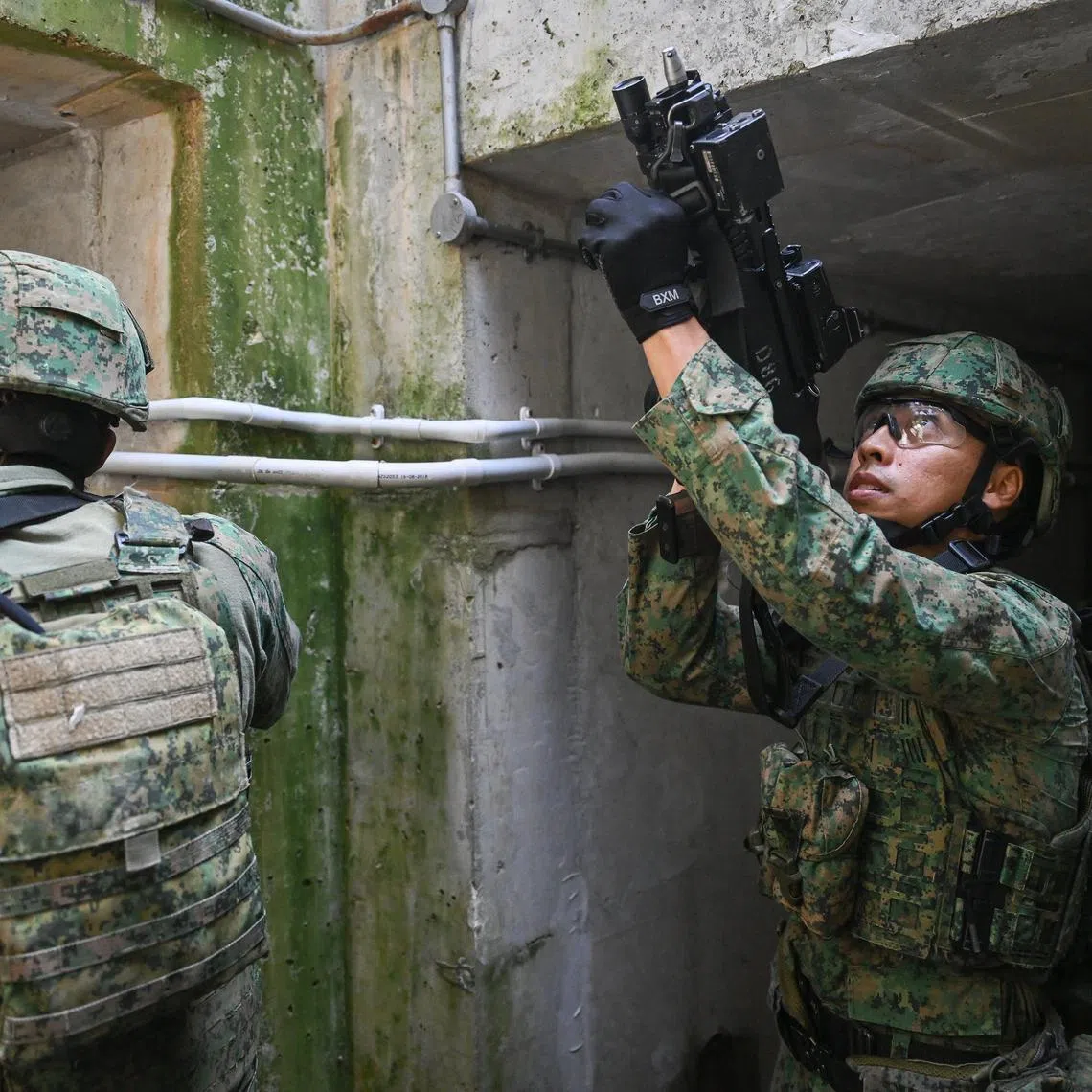 ST20250313_202524000470/mysafti19/Shintaro Tay/Mike Yeo/***Embargoed until March 19, 2025, 5.30pm***Soldiers moving in a drain, as part of an urban ops preview at Safti City on March 13, 2025.
