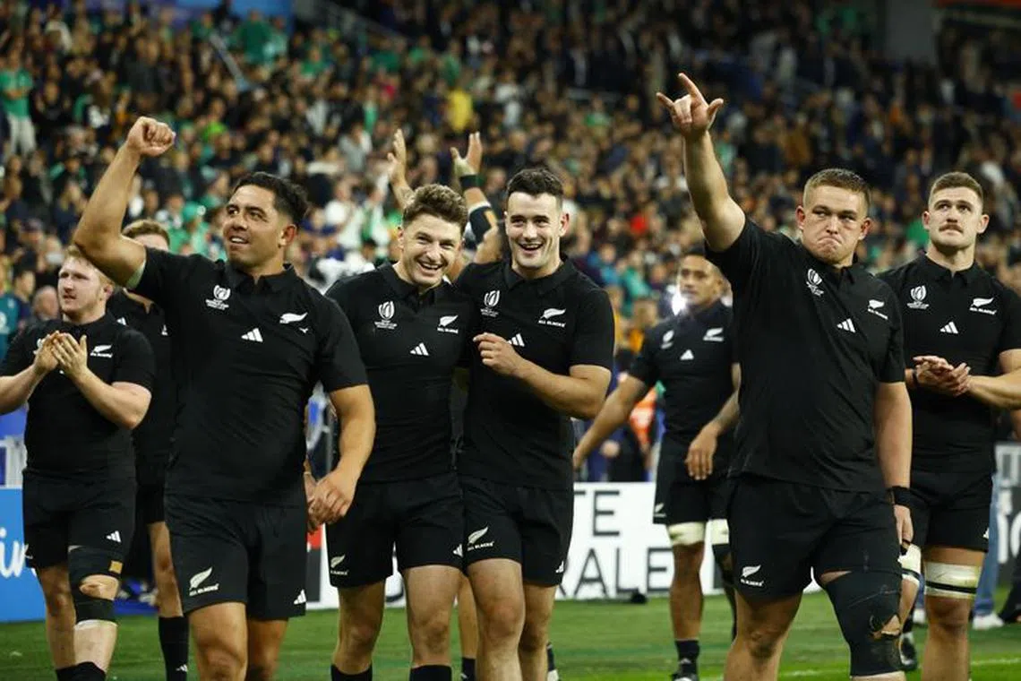 Rugby Union - Rugby World Cup 2023 - Quarter Final - Ireland v New Zealand - Stade de France, Saint-Denis, France - October 14, 2023 New Zealand's Beauden Barrett and Will Jordan celebrate with teammates after the match REUTERS/Sarah Meyssonnier