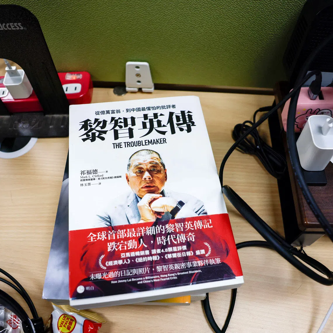A book about media tycoon Jimmy Lai, founder of Apple Daily, lies on a table where former Apple Daily reporters work in Taipei, Taiwan, December 15, 2025. REUTERS/Ann Wang