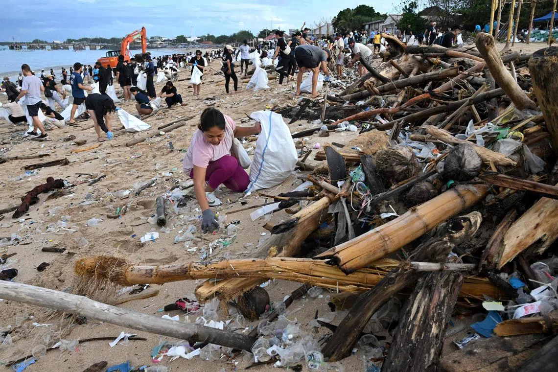 Volunteers remove plastic waste and other garbage washed ashore at a beach in Kedonganan Badung regency, Bali on Jan 4, 2025.