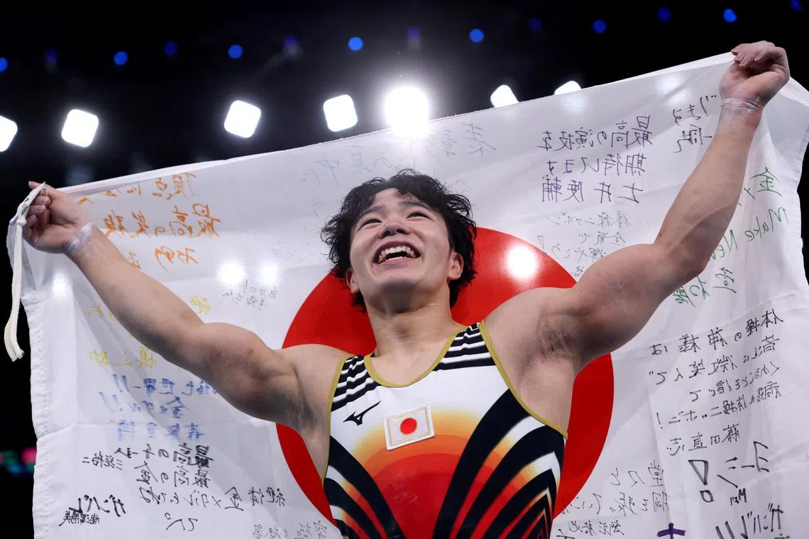 Paris 2024 Olympics - Artistic Gymnastics - Men's All-Around Final - Bercy Arena, Paris, France - July 31, 2024. Shinnosuke Oka of Japan celebrates after winning gold. REUTERS/Amanda Perobelli