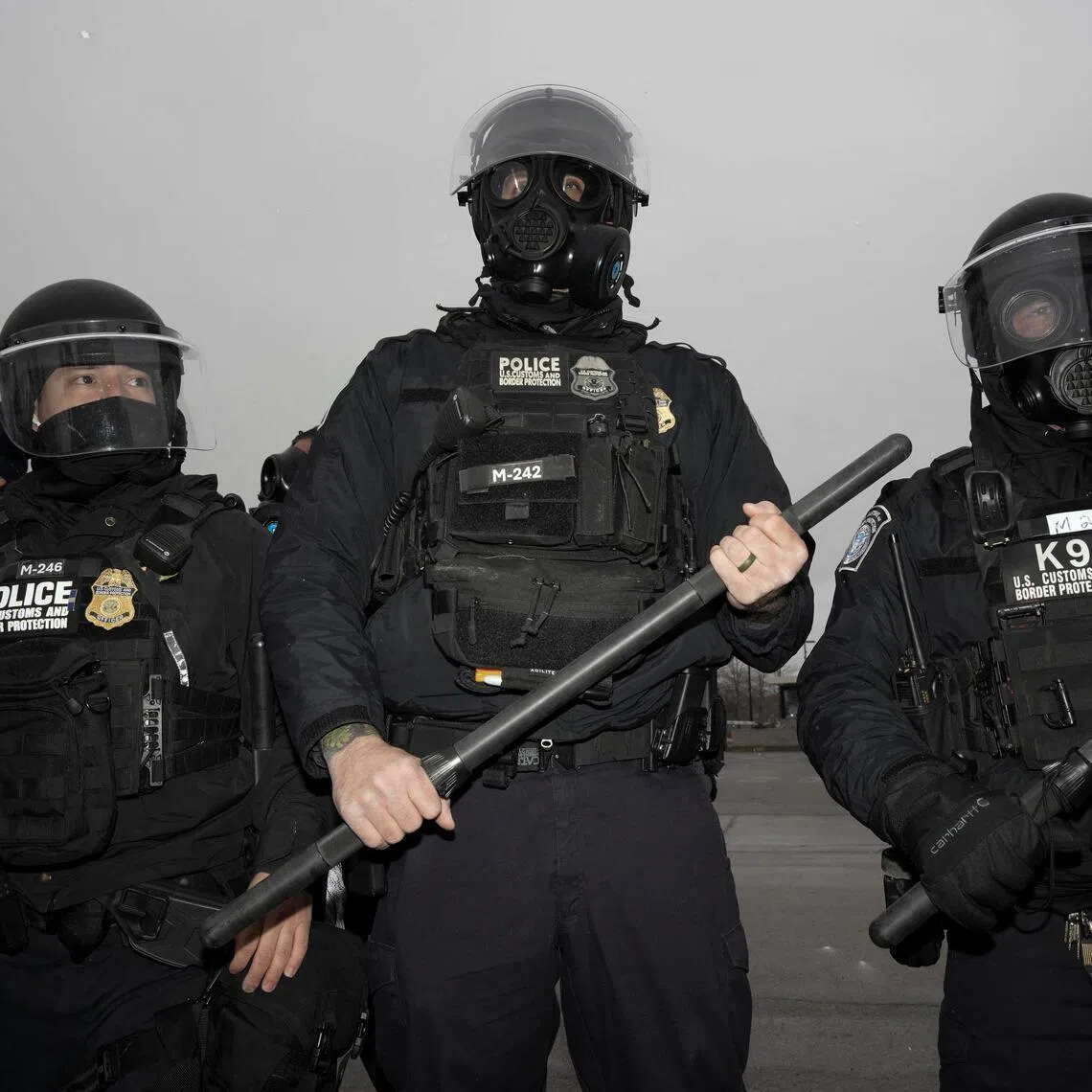 US Customs and Border Protection agents standing guard outside the Whipple Federal Building in Minneapolis, Minnesota, during a Jan 16 protest.