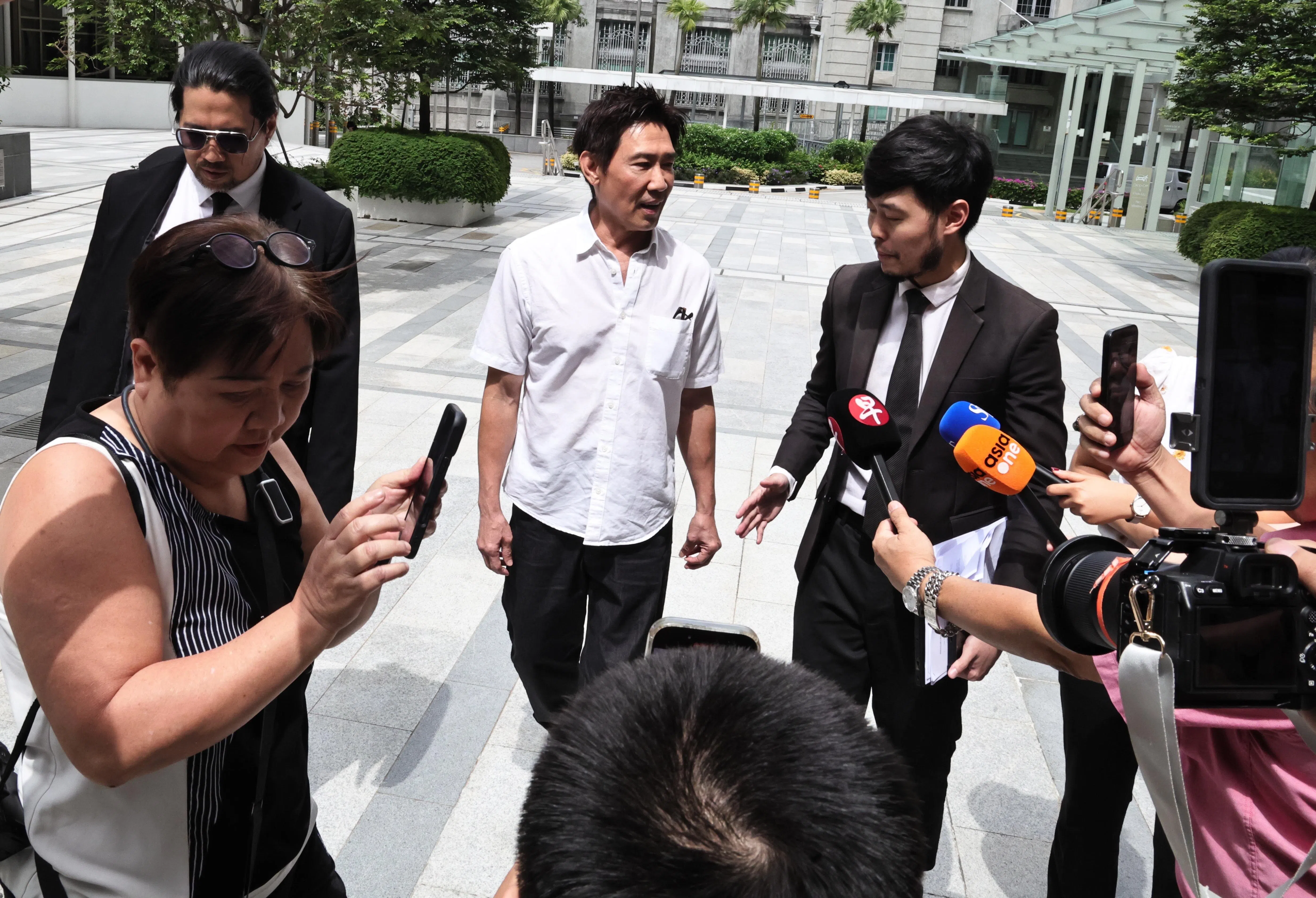 Former actor Edmund Chen arriving at the State Courts with his lawyers on Jan 29.