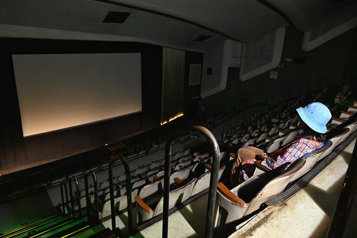 Adora Tan, 28, a film buff, reminiscing her movie experiences at The Projector on Aug 19, 2025. She visited the cinema upon receiving news of its closure.