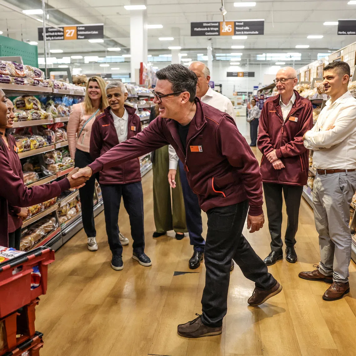 FILE PHOTO: Britain's Prime Minister Andy Burnham greets staff during a visit to a Sainsbury’s store with the Mayor of London Sadiq Khan and Pat McFadden Secretary of State for Work and Pensions, London, Britain, August 26, 2026.  Richard Pohle/Pool via REUTERS/File Photo