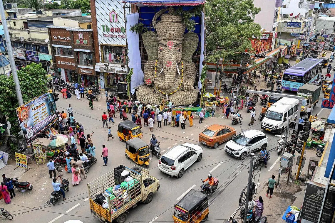 Devotees gathering in front of a 13-metre idol of the Hindu deity Ganesha on the occasion of the Ganesh Chaturthi festival in Chennai on Aug 27, 2025. 