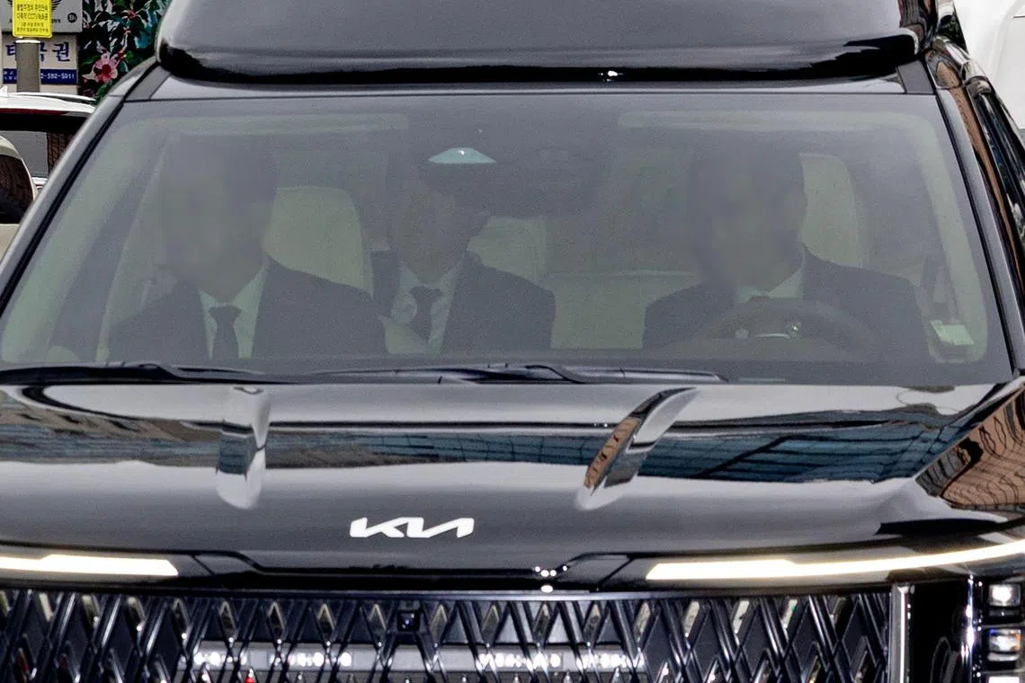 South Korea's ousted president Yoon Suk Yeol (centre, in vehicle) arriving at the Seoul Central District Court in Seoul on April 14 to attend his criminal trial. 