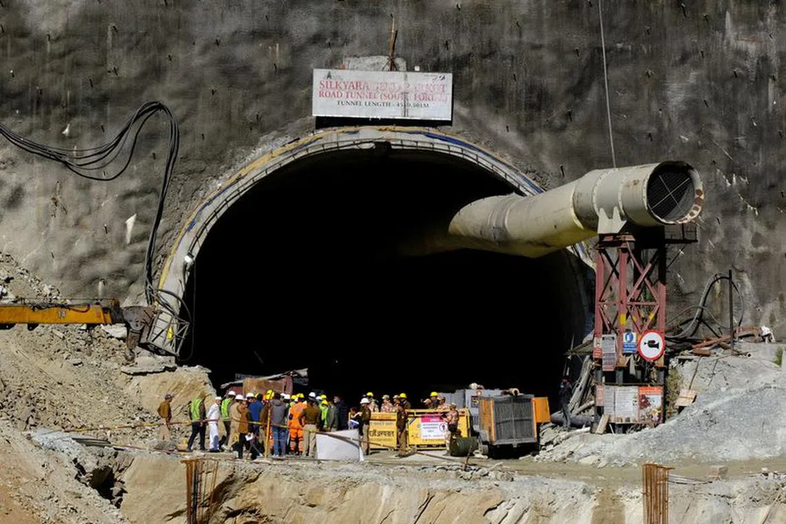 FILE PHOTO: Members of rescue teams stand at the entrance of a tunnel where 40 road workers are trapped after a portion of the tunnel collapsed, in Uttarkashi in the northern state of Uttarakhand, India, November 16, 2023. REUTERS/Shankar Prasad Nautiyal/File photo
